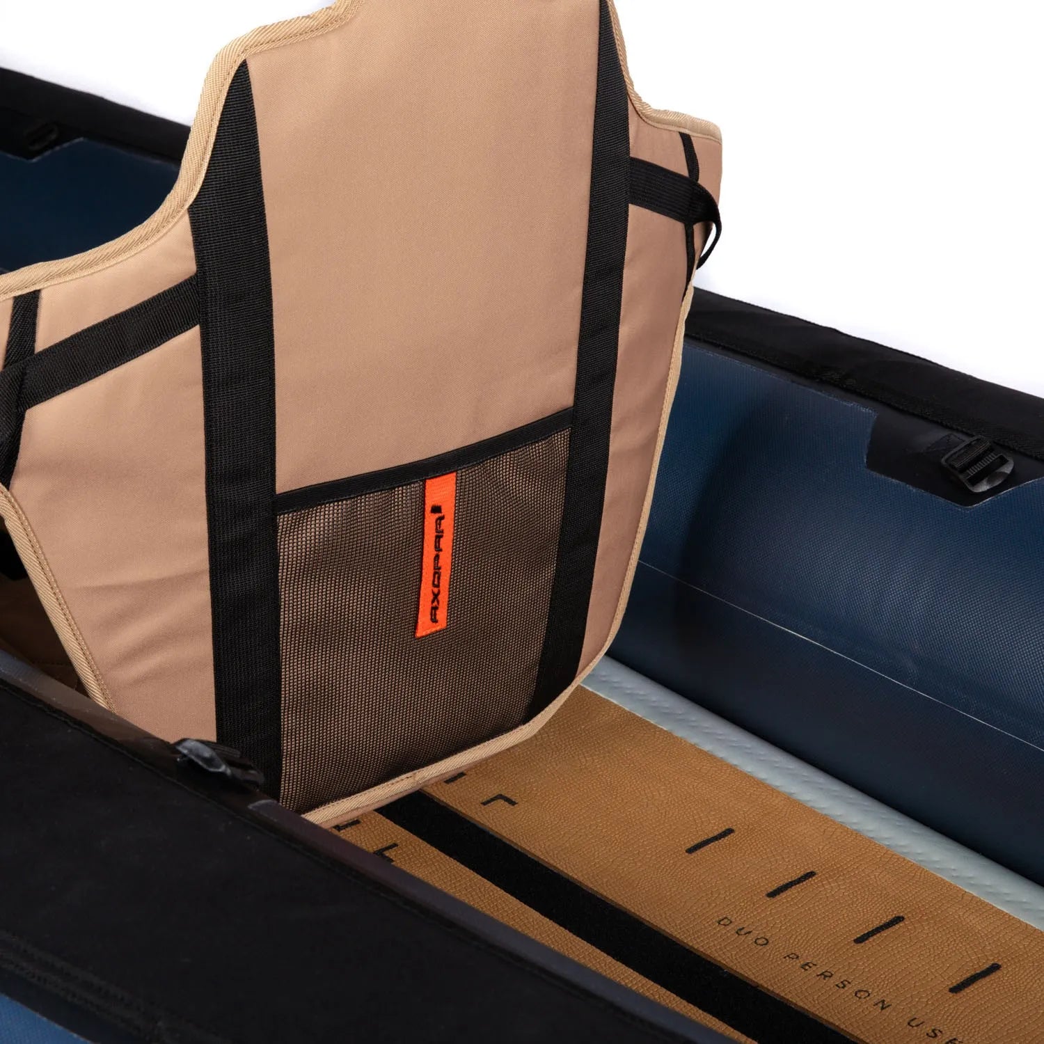 Beige and black seat cover with orange logo on a boat seat