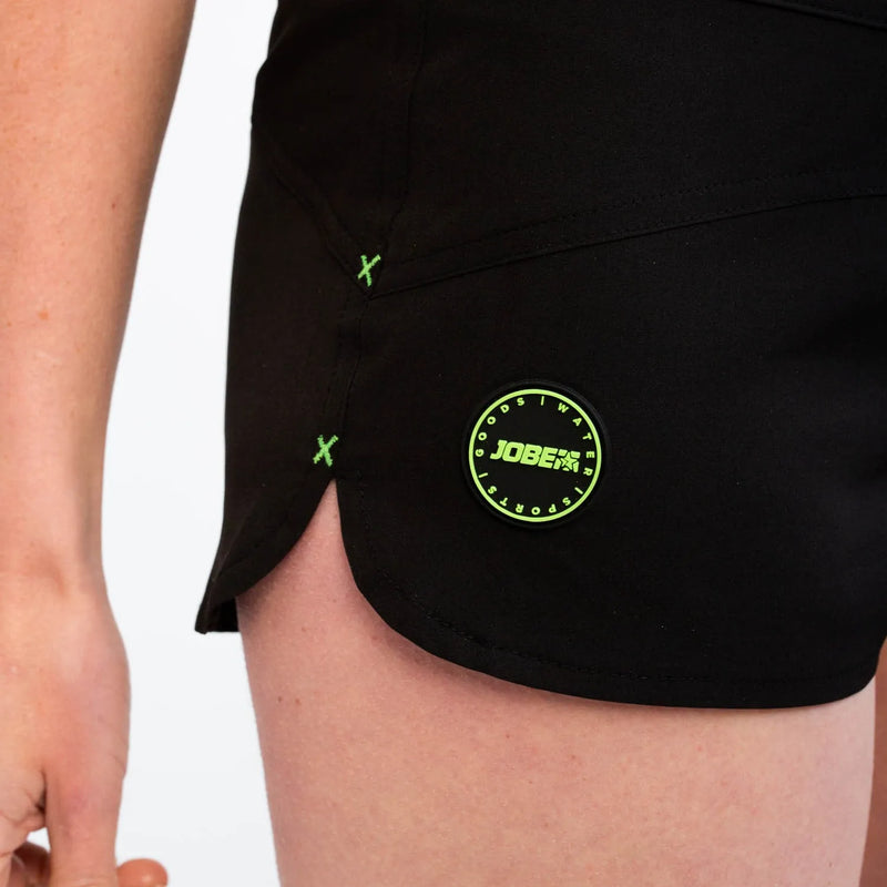 Black athletic skirt with a green logo on a 