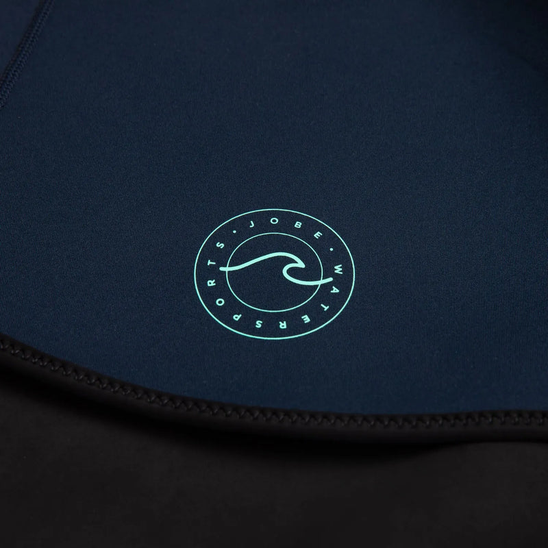 Close-up of a dark blue garment with a green logo on a black background
